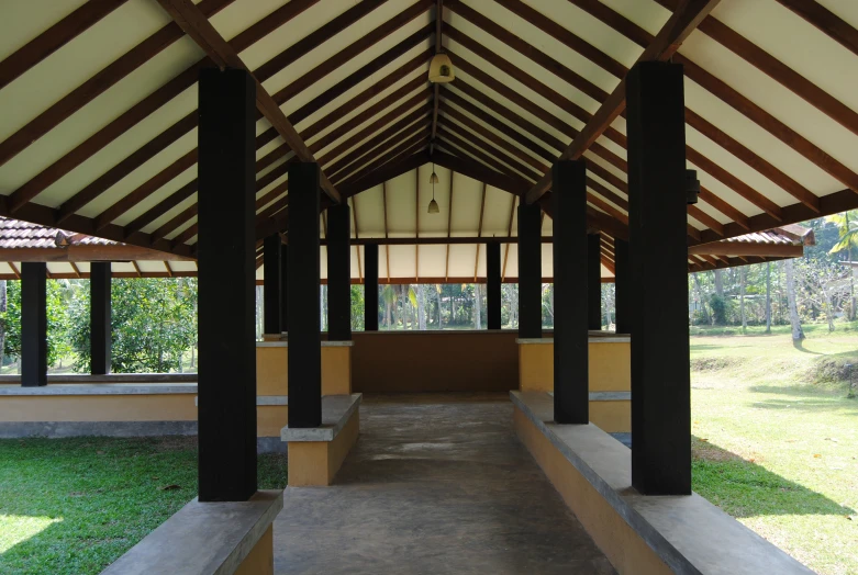 a wooden walkway in the middle of a building with arches on both sides