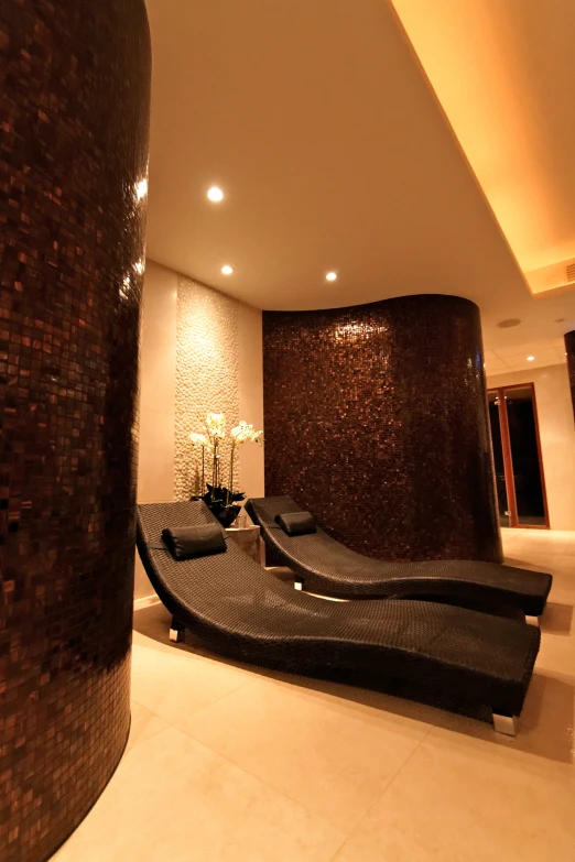 a living room with leather seats and a waterfall