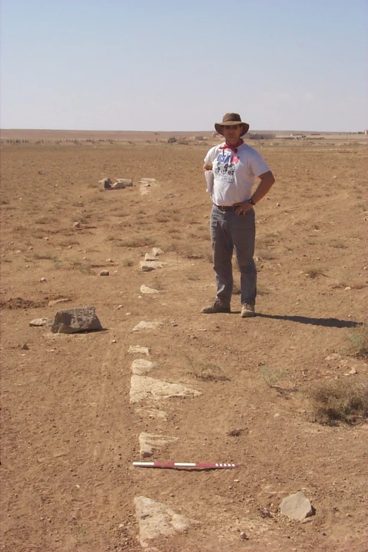 a man wearing a hat in the desert