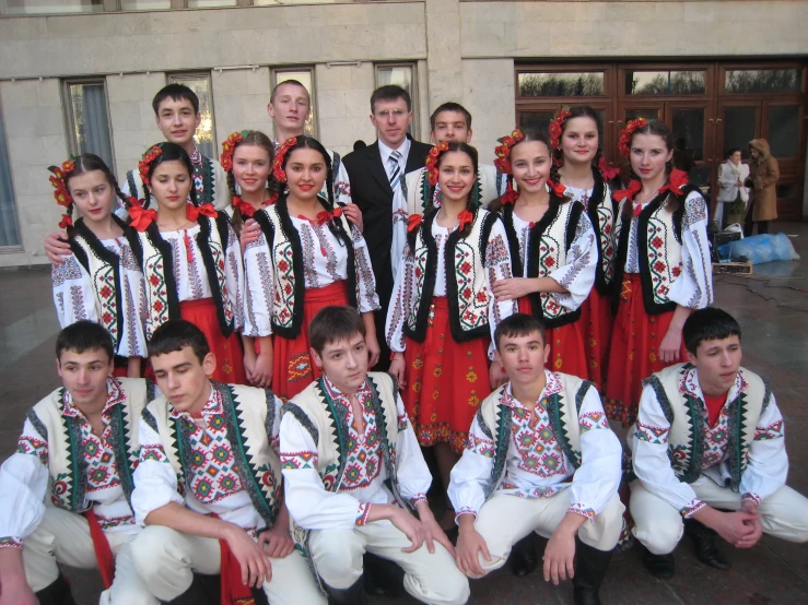 group of young people in traditional dress posing for a picture