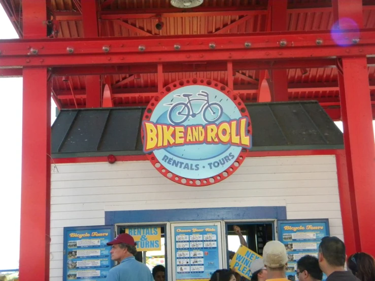 the exterior of a bike and roll shop with a red building