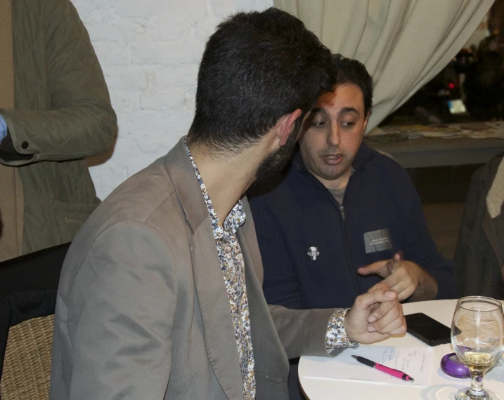 two men are sitting at a table