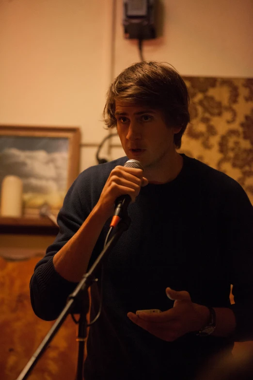 a man standing at a microphone giving a speech