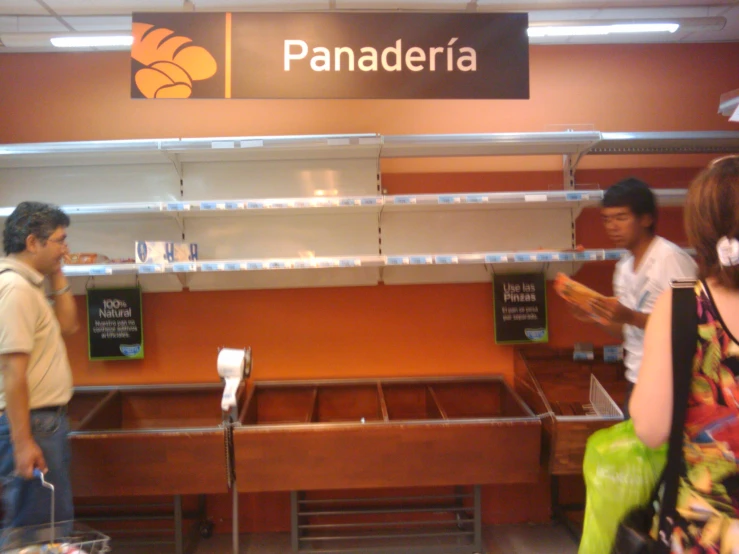 people standing in front of a display case filled with items