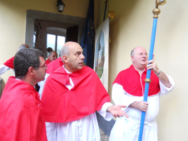 some people dressed up in red are talking to each other