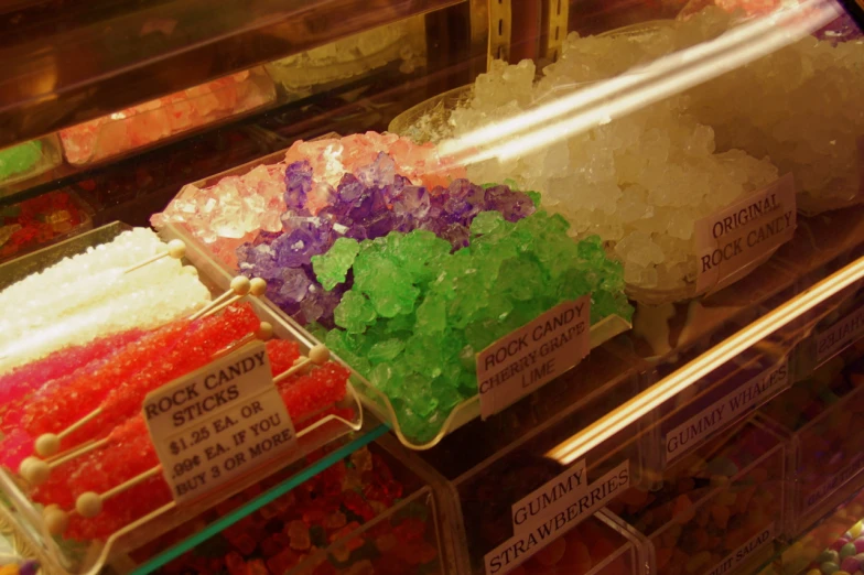 many different color cakes are on display together