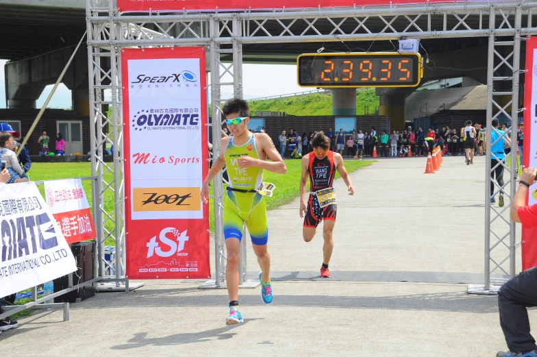 two men running on a sidewalk at the finish line