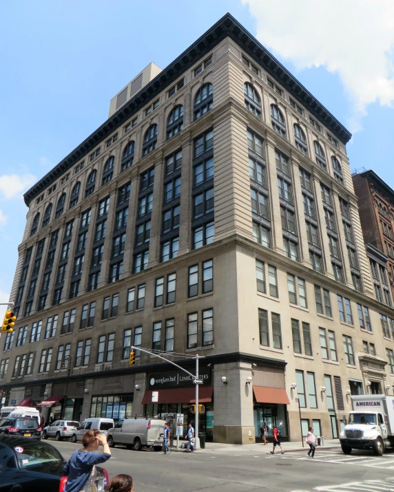 a tall building with many windows sitting on a corner