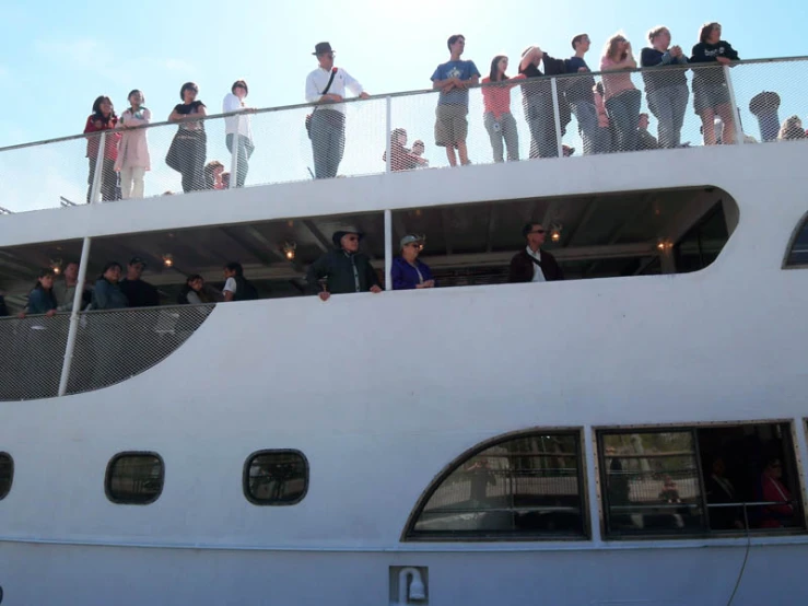 the deck of a cruise ship that is full of people