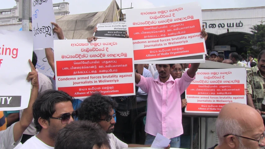 many people standing outside and protesting