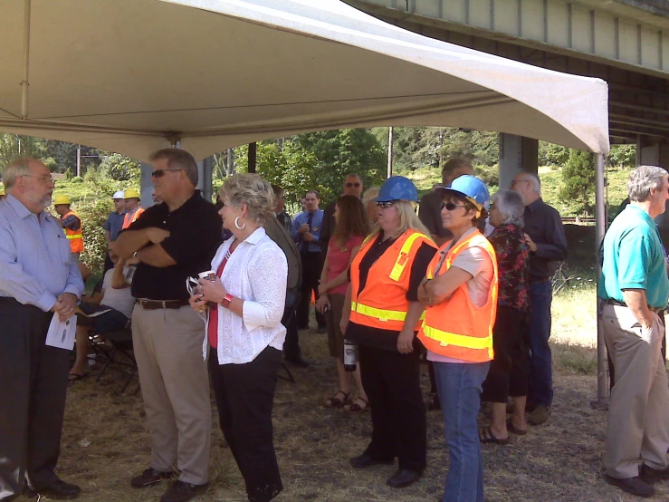 people under a large tent talking to other people