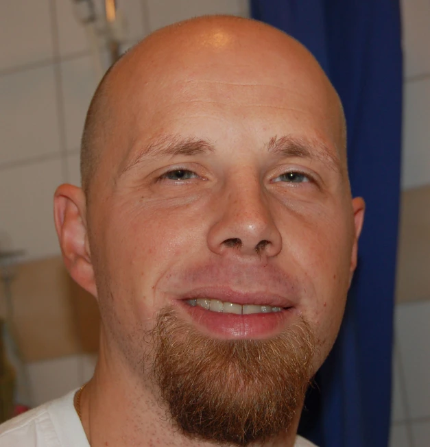 a close up image of a bald man