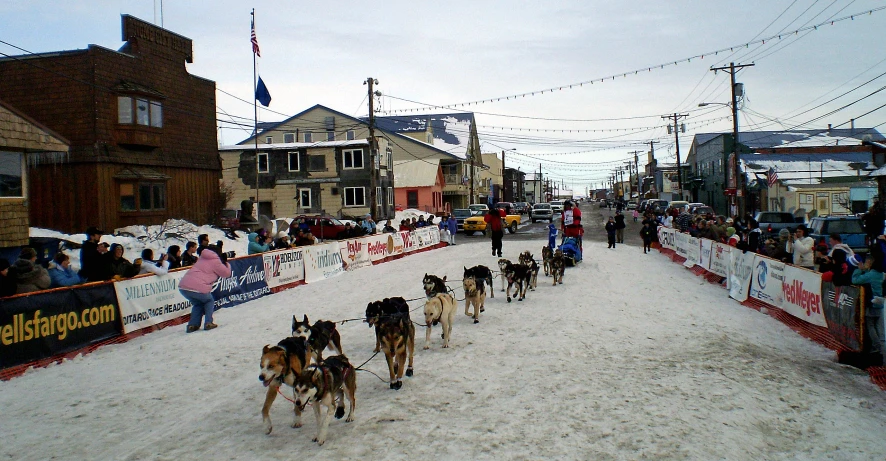 many people are walking on the snow covered street