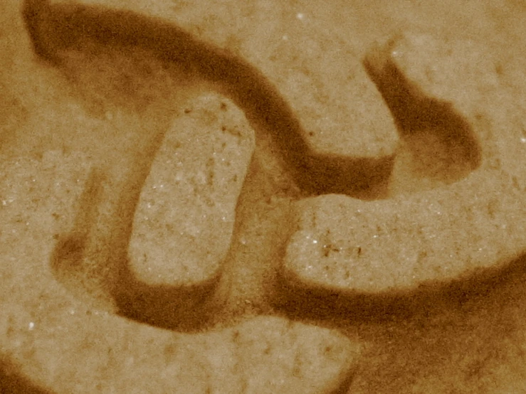 a person writing some type of graffiti on the cement