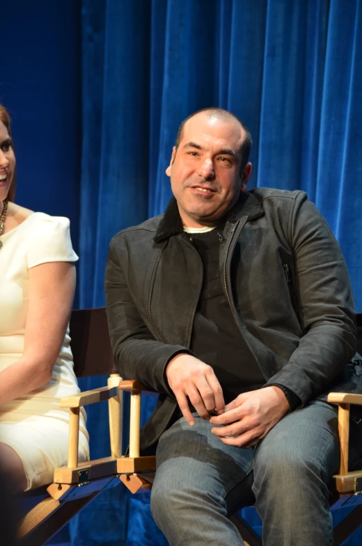 a couple sits down and a priest is smiling