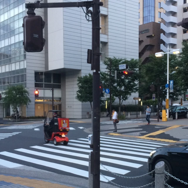 a man riding a motorized vehicle in a cross walk