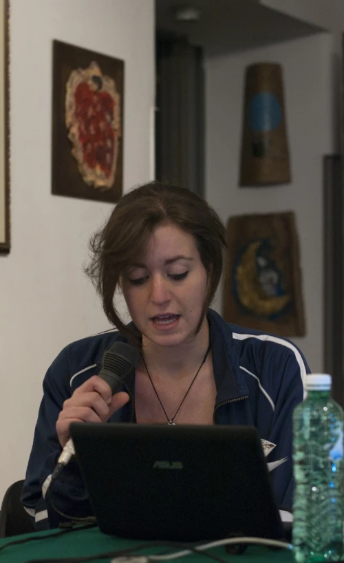 a woman sitting at a desk with her lap top