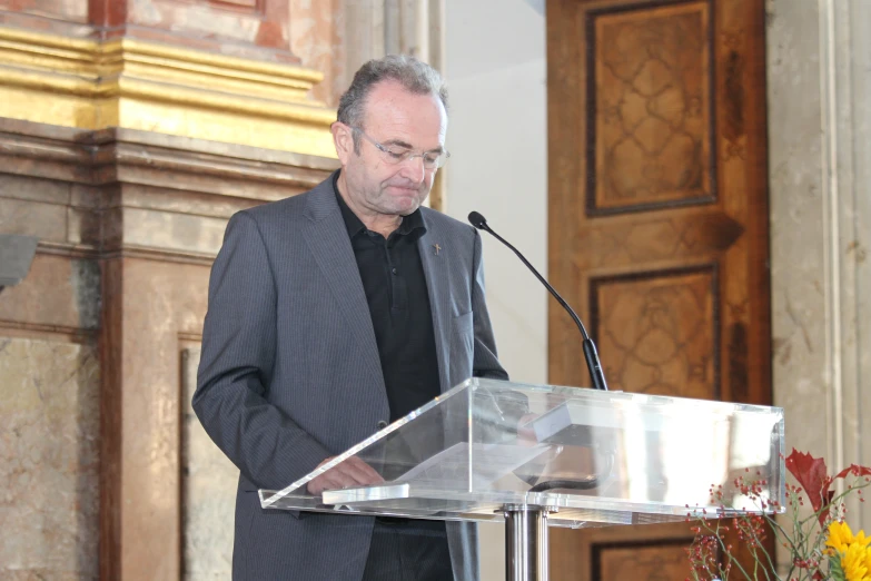 a man standing at a podium making a speech