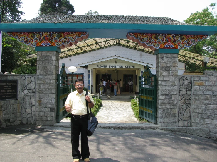 a man posing for a po outside of an entrance