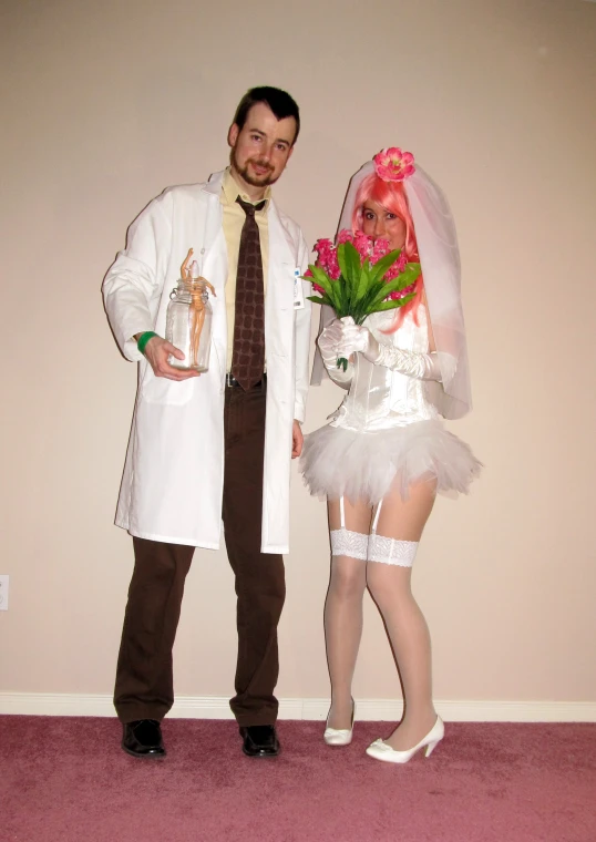 man and woman in costume with fake pink flowers