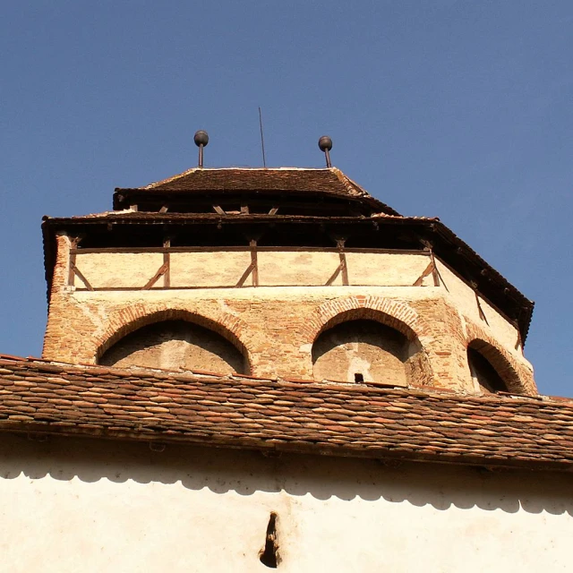 the top portion of a clock tower with a blue sky background