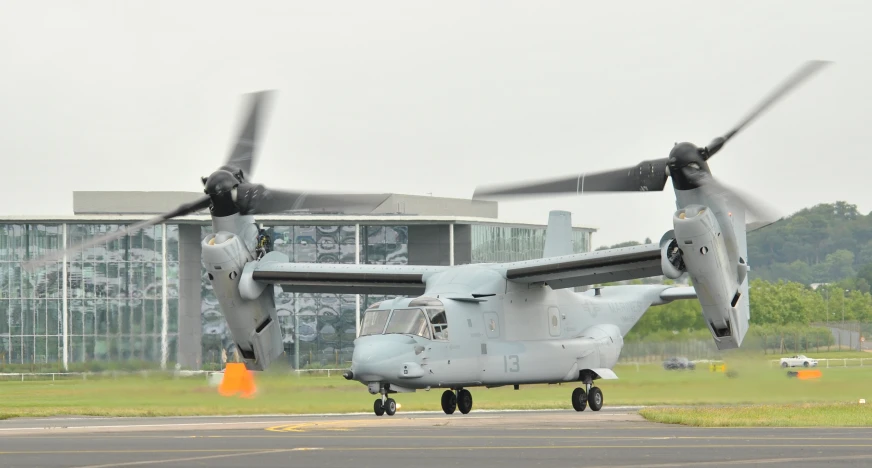 the large helicopter is parked by itself outside