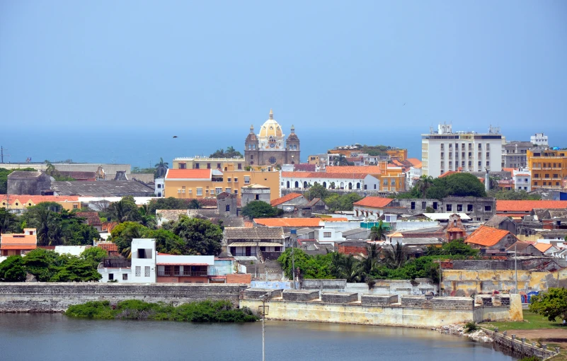 city with orange roof tiles overlooking river and bay