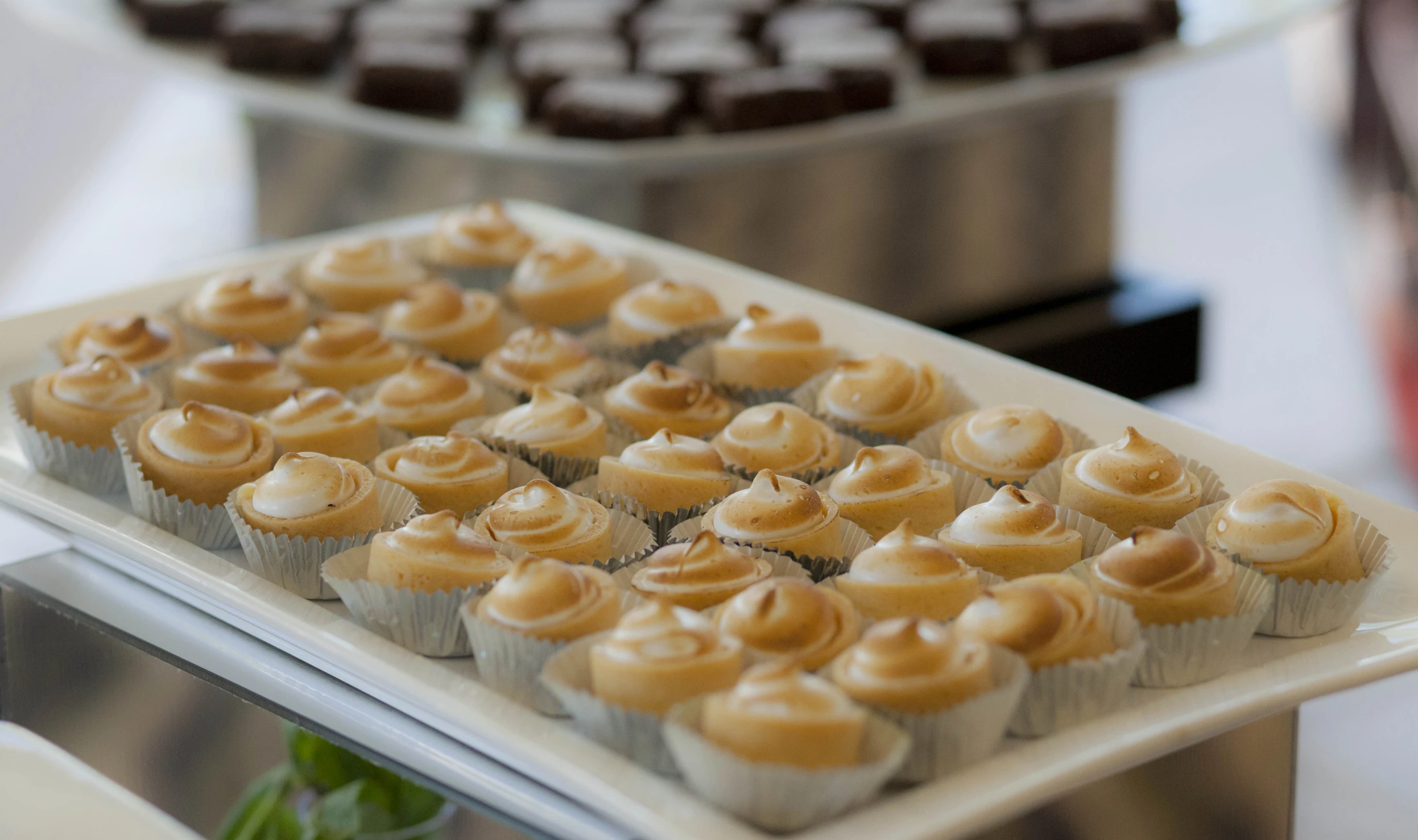 small cupcakes and other desserts on a table