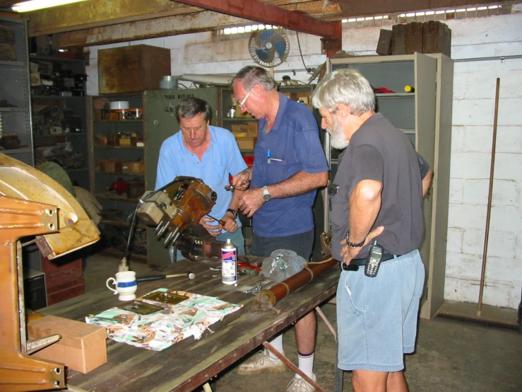 a group of older men working together on soing