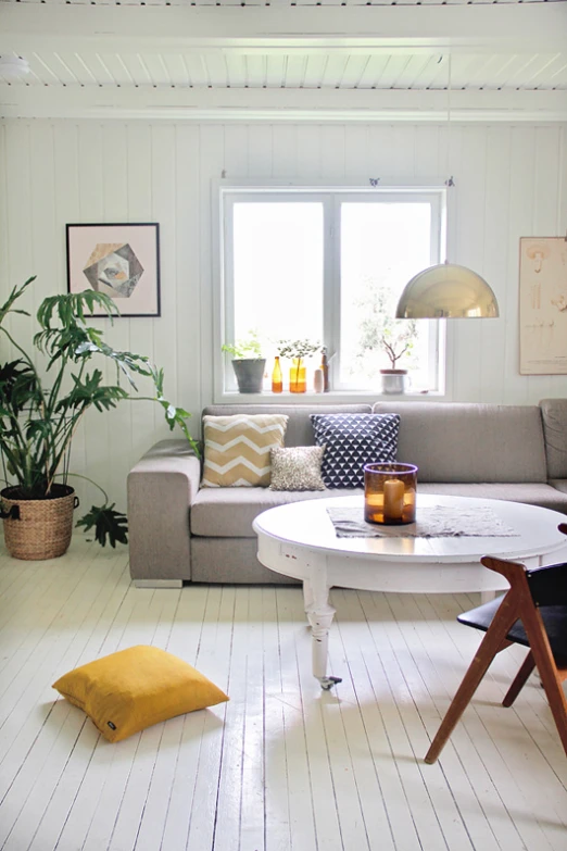 a white room with a couch and some plants