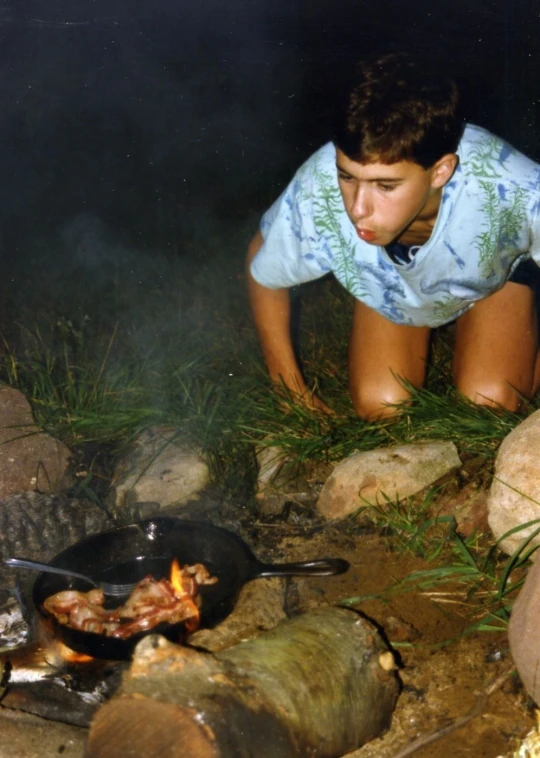 a  cooking food on the grill