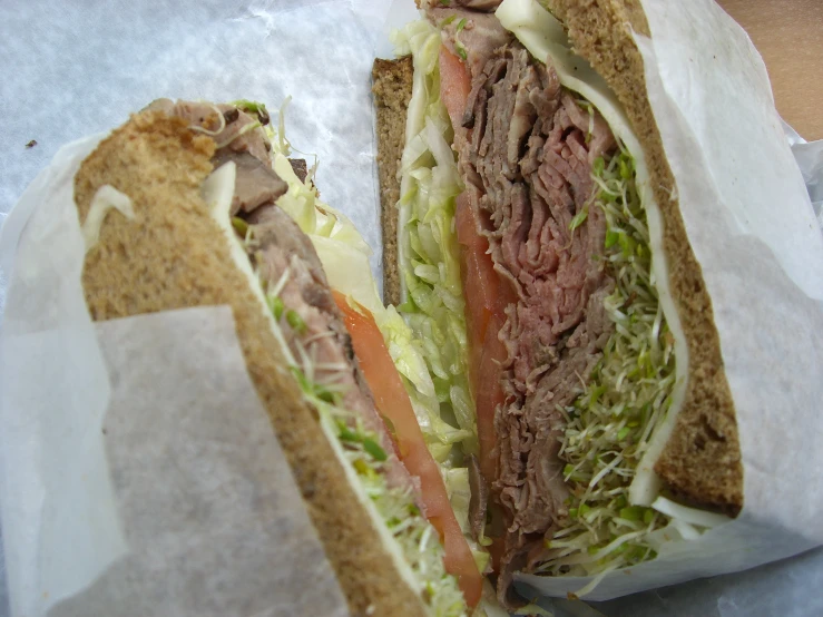 there is a sandwich with meat and lettuce on it