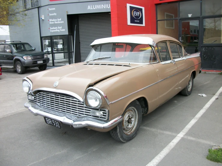 a classic american car parked in front of a shop