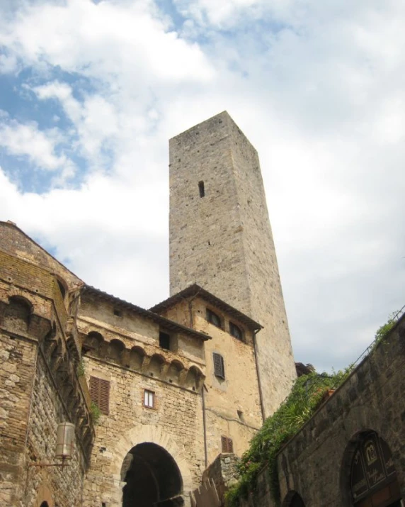 a tall building with two towers towering over another building