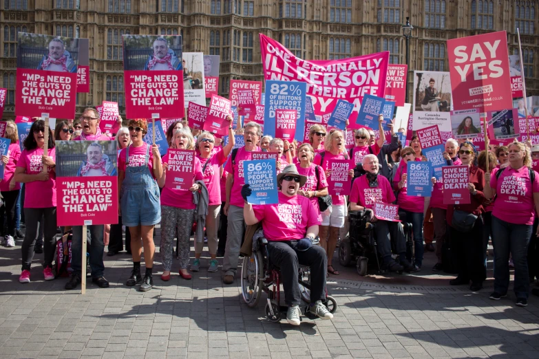 a group of people are holding up signs outside