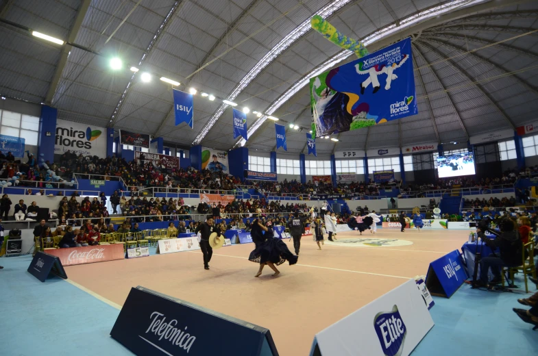 people stand on the court in a convention hall