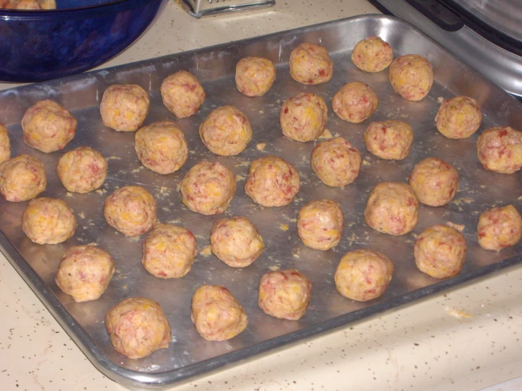 the balls of dough are on the baking pan