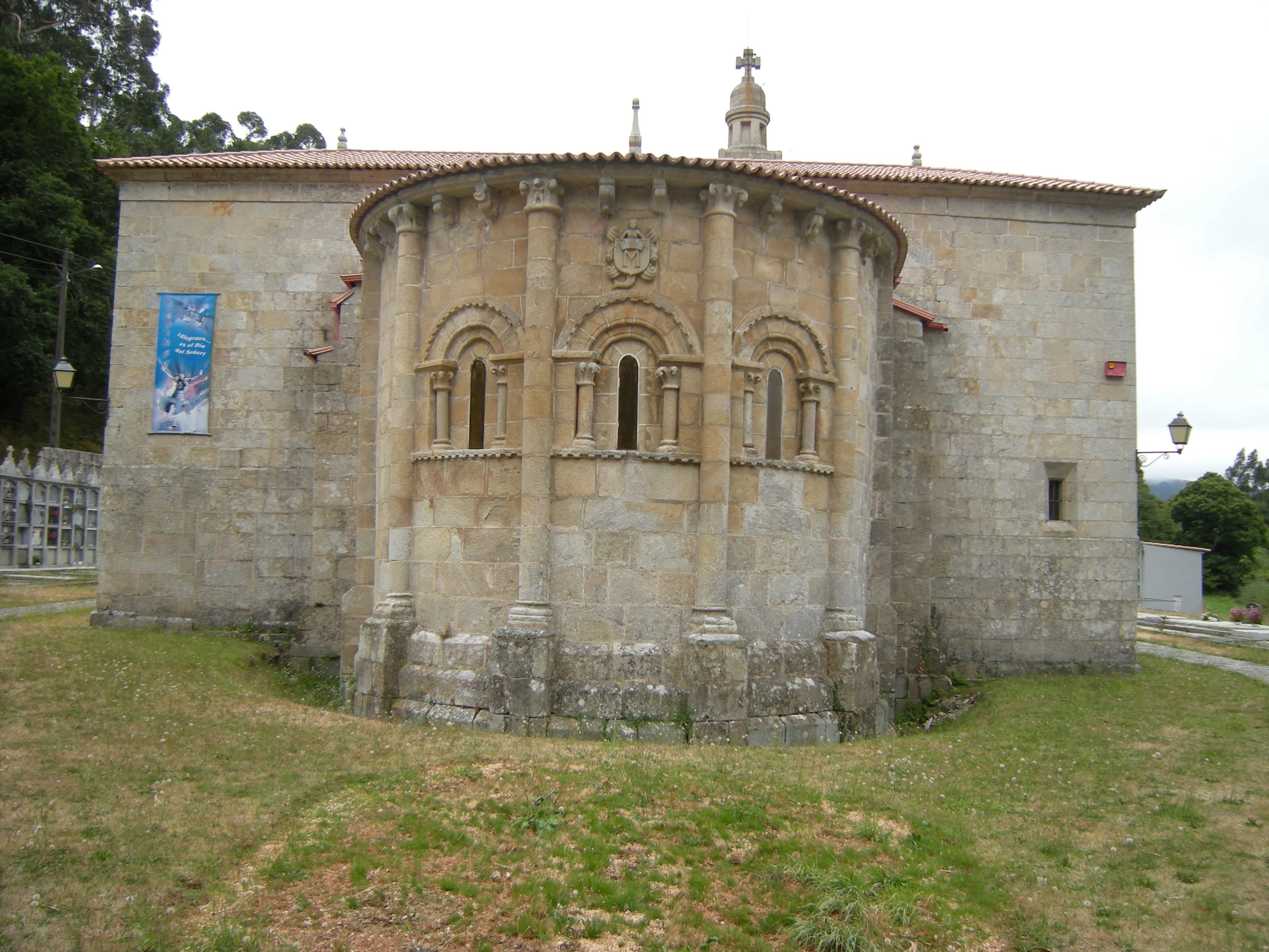 an old church building in a grassy area