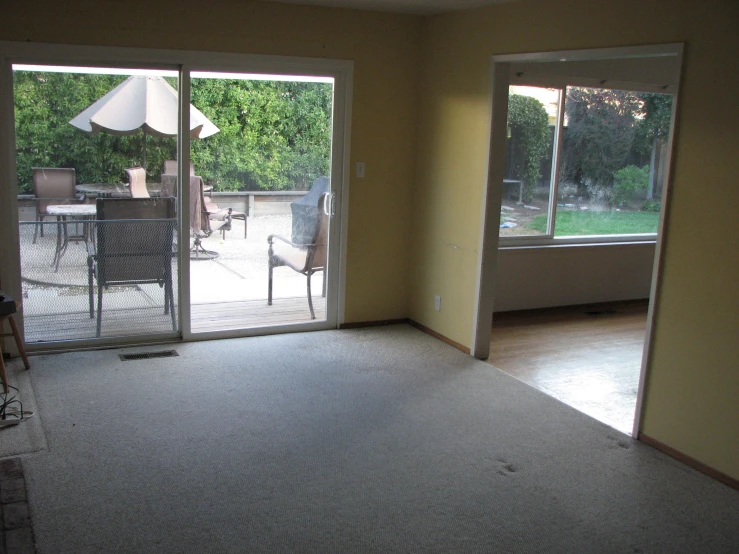 a home patio with sliding glass doors and a view out the outside