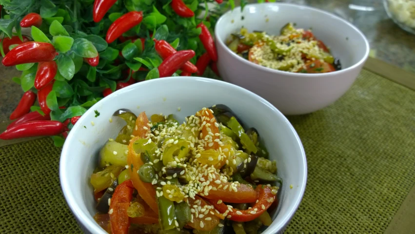 there is a bowl of various vegetables with sesame seeds in it