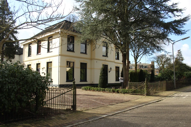 a tall white building next to a street