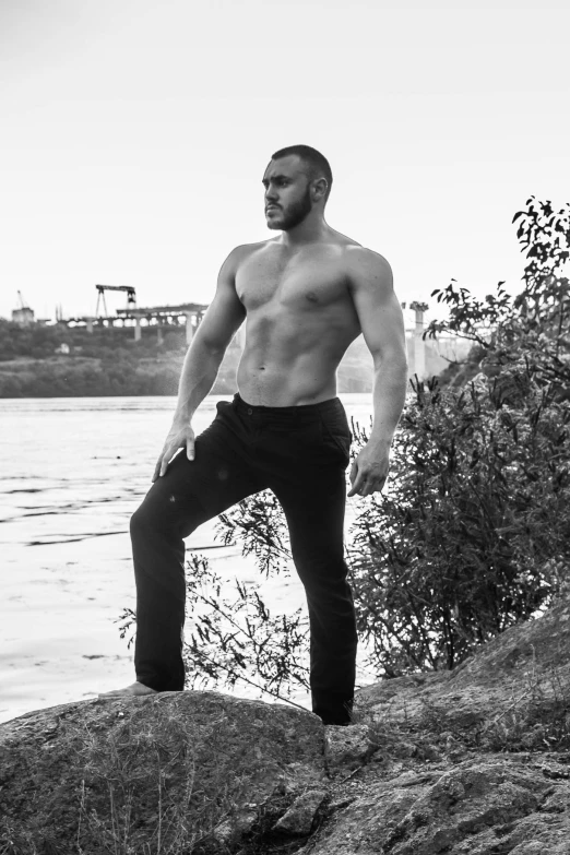 a man standing on a rock overlooking the water