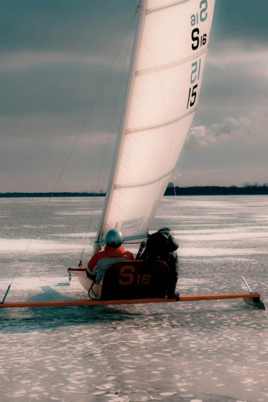 a couple sitting on a sailboat in the water