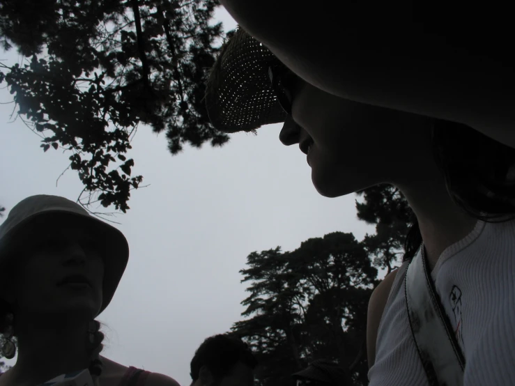 a group of people looking at soing with the sky behind them