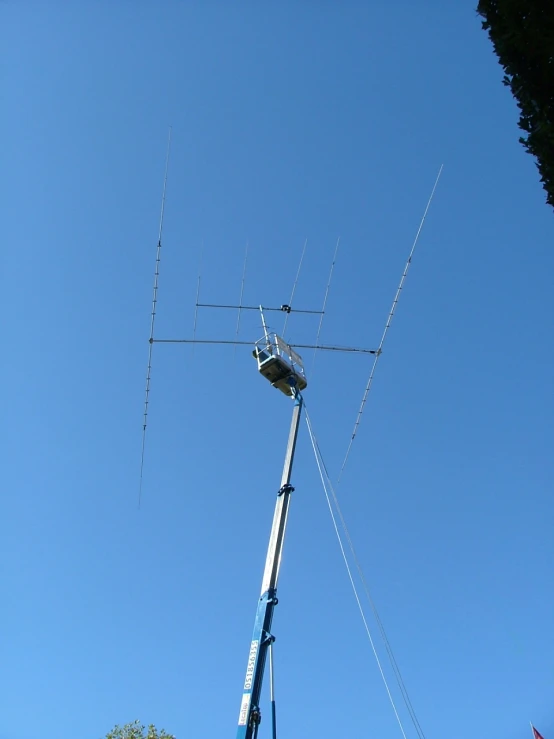 a large antenna sits in the blue sky