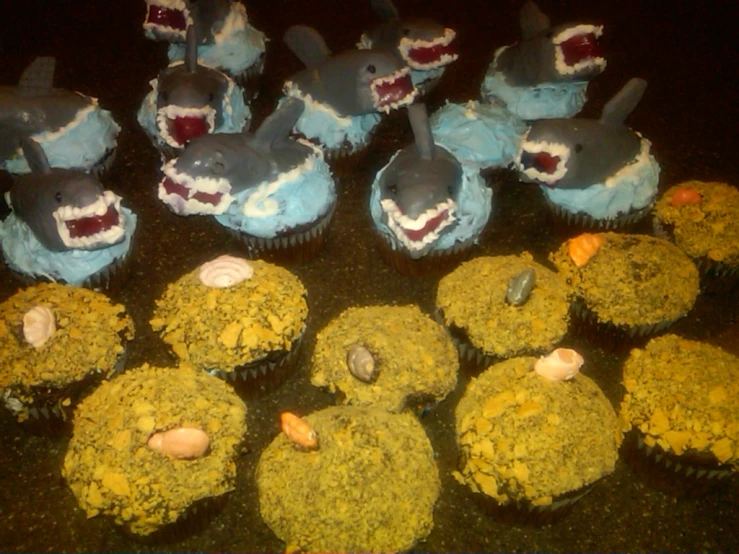 cupcakes that are all decorated like sharks