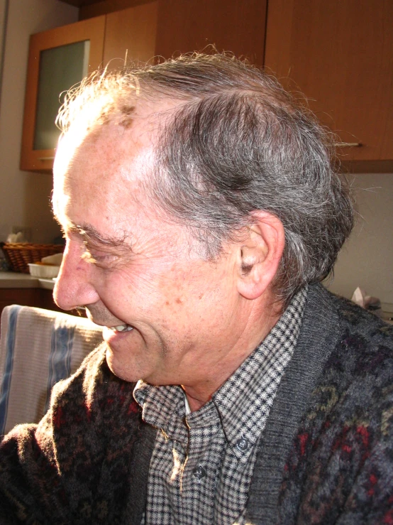 a man smiling in front of a kitchen counter