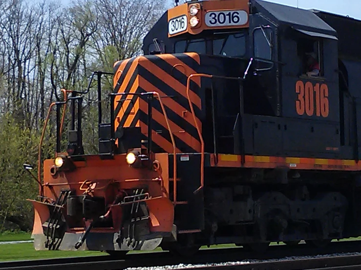 a train engine pulling multiple cars on tracks