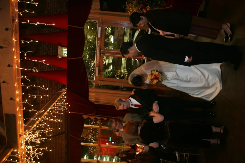 bride and groom standing in front of guests