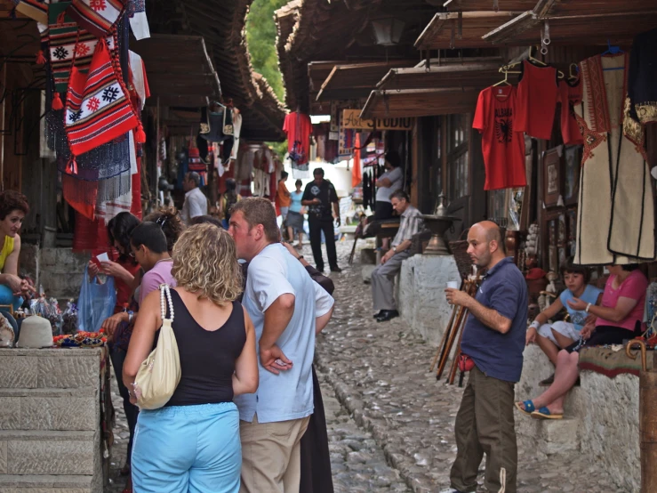 many people are walking around a small village